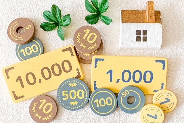 家の模型と1万円・1,000円の札、硬貨を並べた費用イメージ